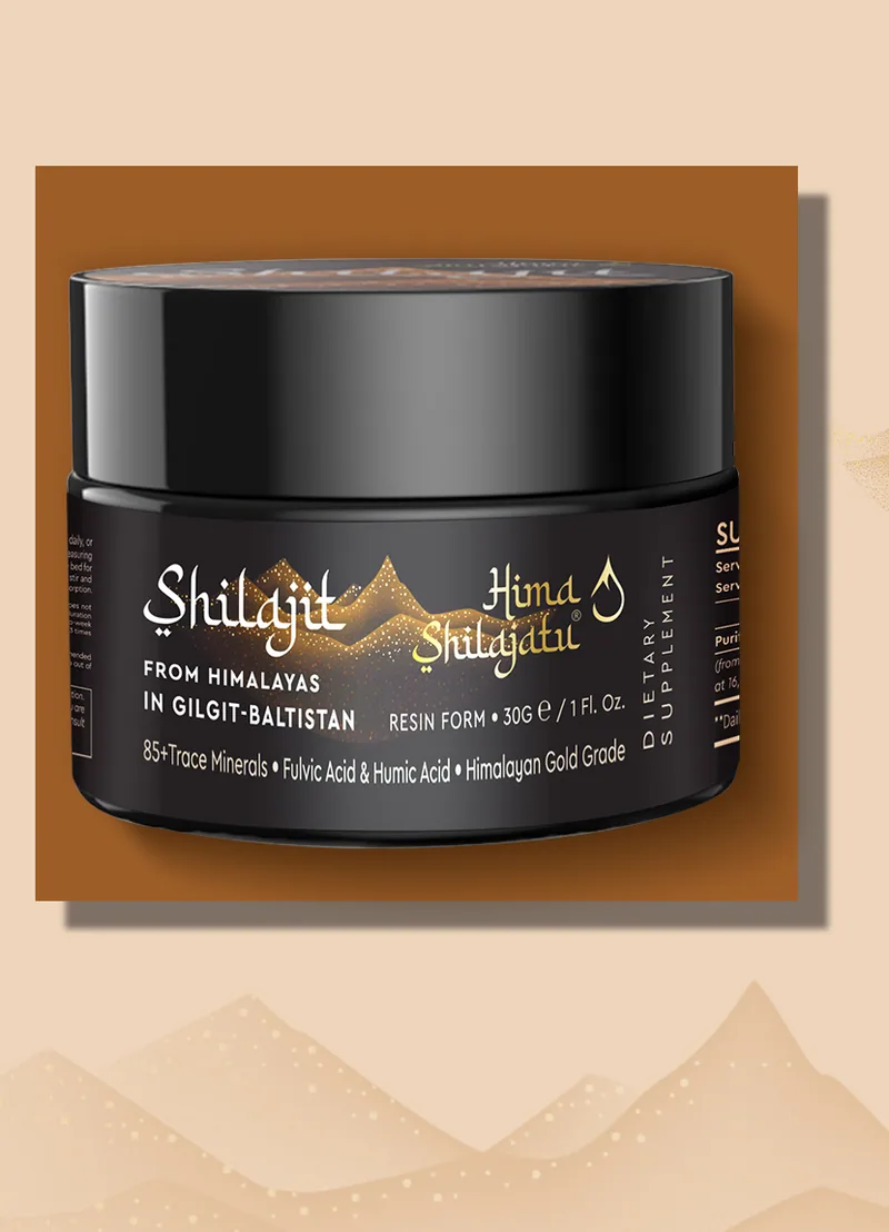 A jar of Hima Shilajatu shilajit resin on a brown panel above a line of sand-colored peaks
